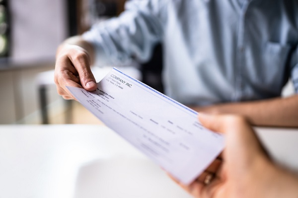 Employee receives their pay with check printing and mailing